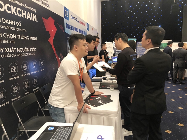 Visitors trial IT solutions at a technology exhibition held recently in HCM City. Software firms in Việt Nam are adding more value to their products through innovative features. — VNS Photo